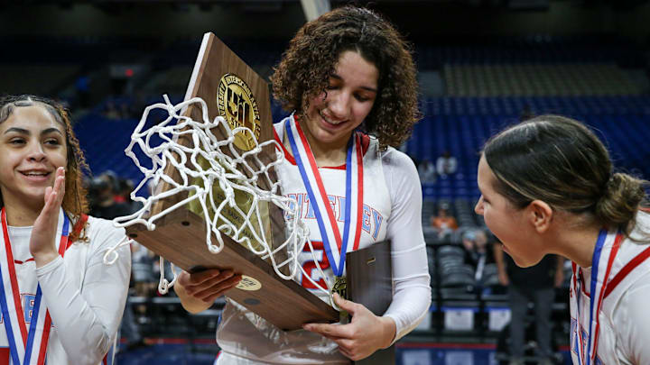 Monterey's Aaliyah Chavez holds the Class 5A Division II state championship girls basketball trophy on Saturday, March 1, 2025, at The Alamodome in San Antonio. Monterey defeated Liberty Hill 64-35.