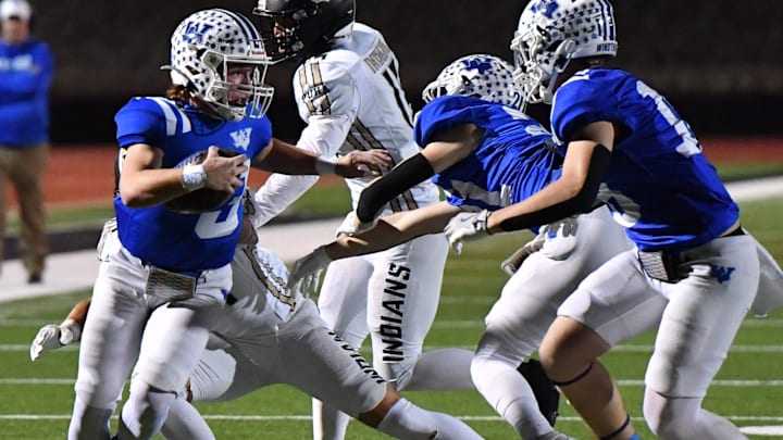 Windthorst's Brock Belcher avoids a Quanah player. 