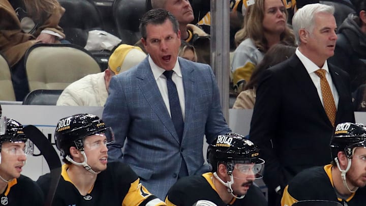 Nov 30, 2024; Pittsburgh, Pennsylvania, USA;  Pittsburgh Penguins head coach Mike Sullivan (rear) reacts on the bench against the Calgary Flames during the third period  at PPG Paints Arena. Mandatory Credit: Charles LeClaire-Imagn Images