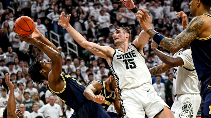 Michigan's Morez Johnson Jr., left, battles Michigan State's Carson Cooper for a rebound during the second half on Friday, Jan. 30, 2026, at the Breslin Center in East Lansing. Michigan's Morez Johnson Jr., left, battles Michigan State's Carson Cooper for a rebound during the second half on Friday, Jan. 30, 2026, at the Breslin Center in East Lansing.