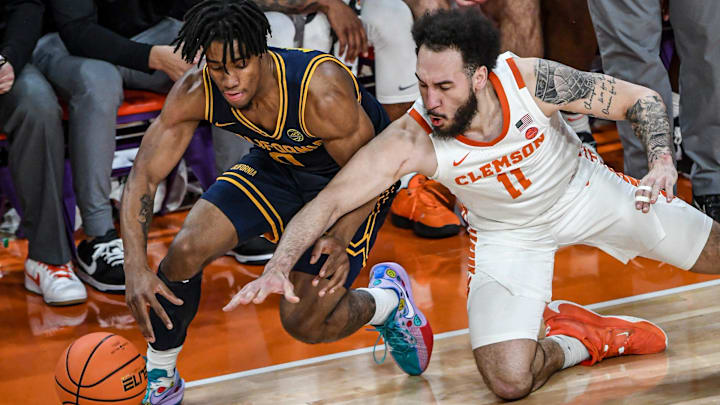 Cal's Jeremiah Wilkinson, left, and Clemson's Jaeden Zachery dive for a loose ball. Cal's Jeremiah Wilkinson, left, and Clemson's Jaeden Zachery dive for a loose ball.