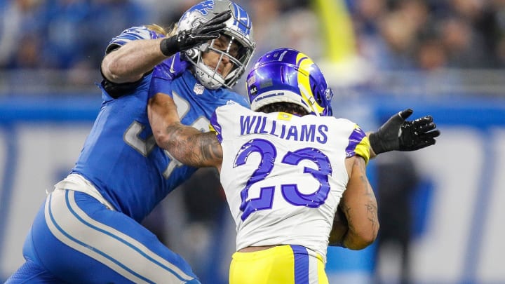 Detroit Lions linebacker Alex Anzalone tackles L.A. Rams running back Kyren Williams during the first half of the NFC wild-card game at Ford Field in Detroit on Sunday, Jan, 14, 2024.
