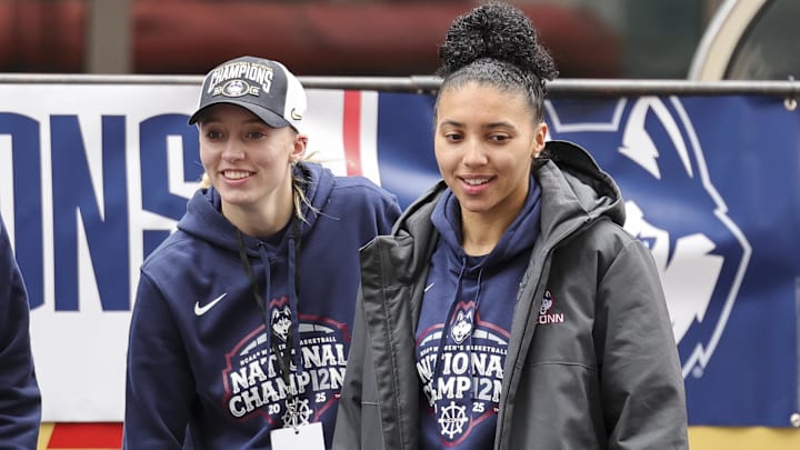 UConn student-athlete Paige Bueckers and UConn student-athlete Azzi Fudd walk onto the stage during the Final Four Champions victory parade and rally outside of the XL Center in Hartford, CT.