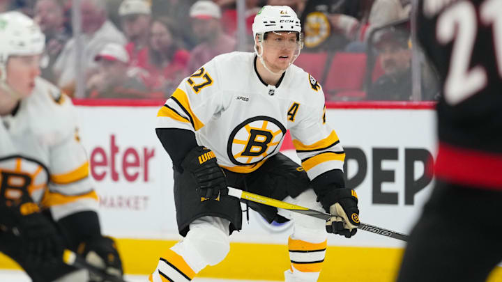 Apr 7, 2026; Raleigh, North Carolina, USA;  Boston Bruins defenseman Hampus Lindholm (27) watches the play against the Carolina Hurricanes during the second period at Lenovo Center. Mandatory Credit: James Guillory-Imagn Images