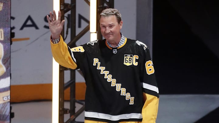 Feb 18, 2024; Pittsburgh, Pennsylvania, USA;  Pittsburgh Penguins former center Mario Lemieux waves to the crowd during a ceremony to retire the jersey number of Penguins former right wing Jaromir Jagr (not pictured) at PPG Paints Arena. The Penguins hosted the Los Angeles Kings after the ceremony. Los Angeles won 2-1. Mandatory Credit: Charles LeClaire-Imagn Images