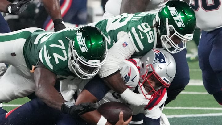 Sep 19, 2024; East Rutherford, New Jersey, USA; New England Patriots quarterback Jacoby Brissett (7) sacked by New York Jets defensive end Micheal Clemons (72) and defensive end Will McDonald IV (99) in the 1st half at MetLife Stadium. Sep 19, 2024; East Rutherford, New Jersey, USA; New England Patriots quarterback Jacoby Brissett (7) sacked by New York Jets defensive end Micheal Clemons (72) and defensive end Will McDonald IV (99) in the 1st half at MetLife Stadium.