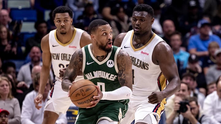 Milwaukee Bucks guard Damian Lillard (0) looks to pass the ball against New Orleans Pelicans forward Zion Williamson (1) and guard Trey Murphy III (25) during the second half at Smoothie King Center. Mandatory Credit: Stephen Lew-Imagn Images