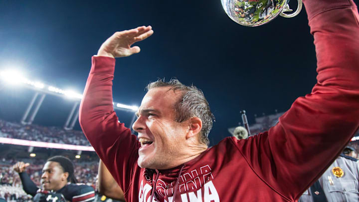 Nov 16, 2024; Columbia, South Carolina, USA; South Carolina Gamecocks head coach Shane Beamer celebrates beating the Missouri Tigers at Williams-Brice Stadium. He is holding the Mayors Cup, given to the winner of the South Carolina-Missouri game. Mandatory Credit: Jeff Blake-Imagn Images