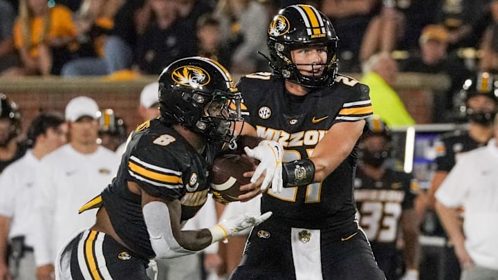 Aug 31, 2023; Columbia, Missouri, USA; Missouri Tigers quarterback Sam Horn (21) hands off to running back Nathaniel Peat (8) against the South Dakota Coyotes during the second half at Faurot Field at Memorial Stadium. Mandatory Credit: Denny Medley-Imagn Images