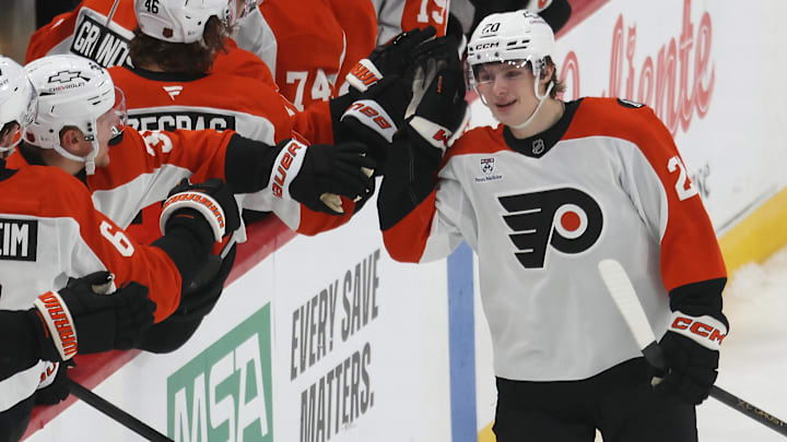 Mar 7, 2026; Pittsburgh, Pennsylvania, USA;  Philadelphia Flyers left wing Alex Bump (20) celebrates with the Flyers bench after scoring his first NHL goal in his NHL debut against the Pittsburgh Penguins during the second period at PPG Paints Arena.