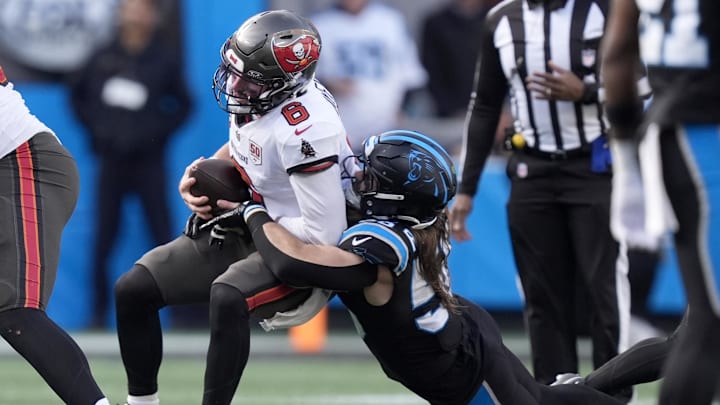Dec 21, 2025; Charlotte, North Carolina, USA; Carolina Panthers linebacker Christian Rozeboom (56) tackles Tampa Bay Buccaneers quarterback Baker Mayfield (6) during the second half at Bank of America Stadium. Mandatory Credit: Jim Dedmon-Imagn Images