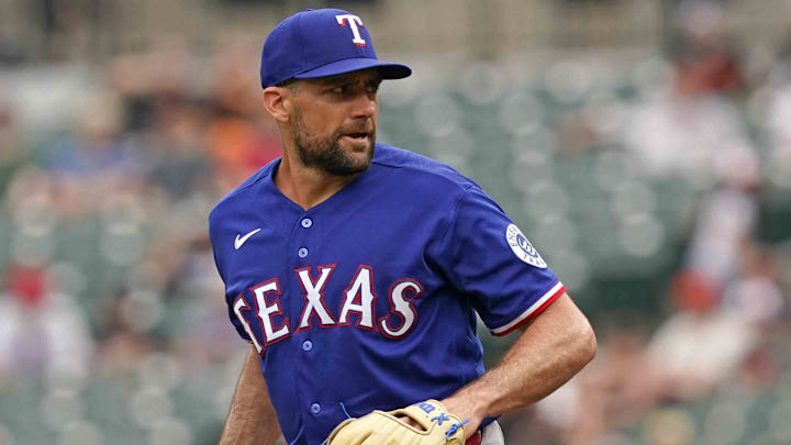 Apr 1, 2026; Baltimore, Maryland, USA; Texas Rangers pitcher Nathan Eovaldi (left) delivers during the first inning against the Baltimore Orioles at Oriole Park at Camden Yards. Mandatory Credit: Mitch Stringer-Imagn Images