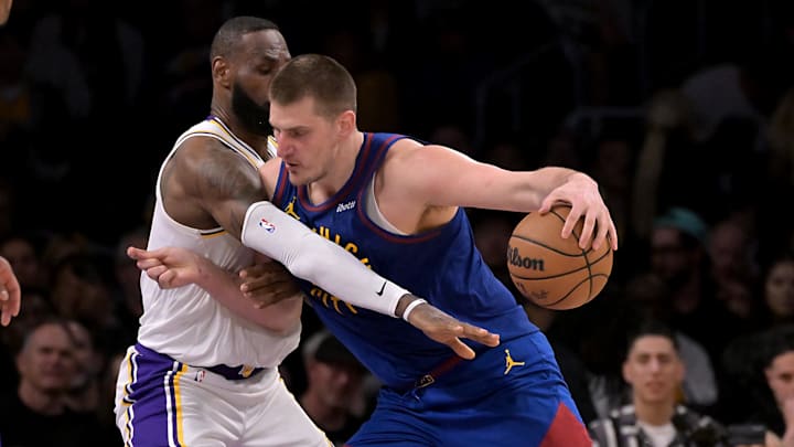 Mar 2, 2024; Los Angeles, California, USA;  Los Angeles Lakers forward LeBron James (23) guards Nikola Jokic (15)