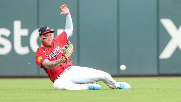 Jun 13, 2025; Cumberland, Georgia, USA; Atlanta Braves outfielder makes an error in the field against the Colorado Rockies during the second inning at Truist Park. Mandatory Credit: Jordan Godfree-Imagn Images Jun 13, 2025; Cumberland, Georgia, USA; Atlanta Braves outfielder makes an error in the field against the Colorado Rockies during the second inning at Truist Park. Mandatory Credit: Jordan Godfree-Imagn Images