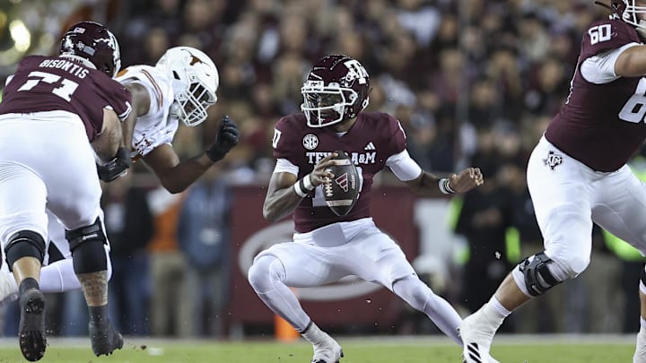 Nov 30, 2024; College Station, Texas, USA; Texas A&M Aggies quarterback Marcel Reed (10) scrambles with the ball during the first quarter against the Texas Longhorns at Kyle Field. Mandatory Credit: Troy Taormina-Imagn Images
