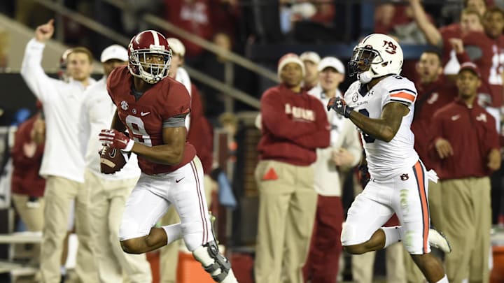 Nov 29, 2014; Tuscaloosa, AL, USA; Alabama Crimson Tide wide receiver Amari Cooper (9) catches a touchdown pass in the third quarter  past Auburn Tigers defensive back Jonathon Mincy (6) at Bryant-Denny Stadium. Mandatory Credit: John David Mercer-Imagn Images