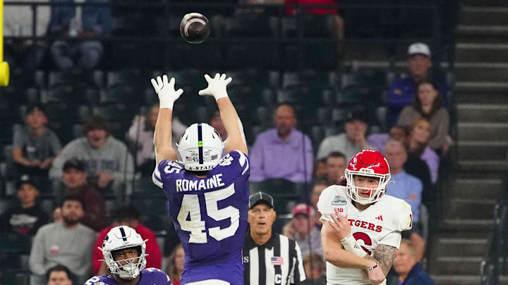 Kansas State linebacker Austin Romaine tries to deflect pass from Rutgers quarterback Athan Kaliakmanis.