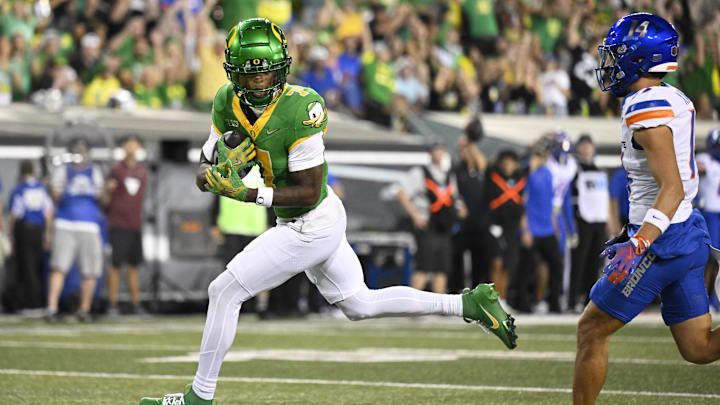 Sep 7, 2024; Eugene, Oregon, USA; Oregon Ducks wide receiver Evan Stewart (7) catches a touchdown pass during the first half against Boise State Broncos safety Kaonohi Kaniho (14) at Autzen Stadium. Mandatory Credit: Troy Wayrynen-Imagn Images