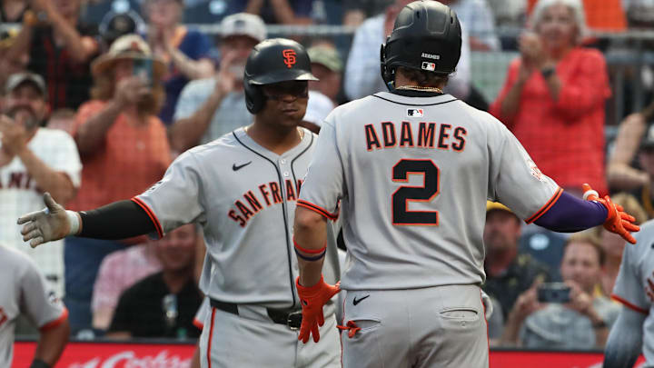 Aug 5, 2025; Pittsburgh, Pennsylvania, USA;  San Francisco Giants designated hitter Rafael Devers (left) greets shortstop Willy Adames (2) crossing home plate on a two-run home run against the Pittsburgh Pirates during the fifth inning at PNC Park. 