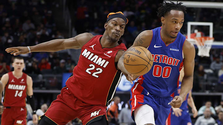 Dec 16, 2024; Detroit, Michigan, USA;  Miami Heat forward Jimmy Butler (22) knocks the ball away from Detroit Pistons forward Ronald Holland II (00) in the second half at Little Caesars Arena. Mandatory Credit: Rick Osentoski-Imagn Images