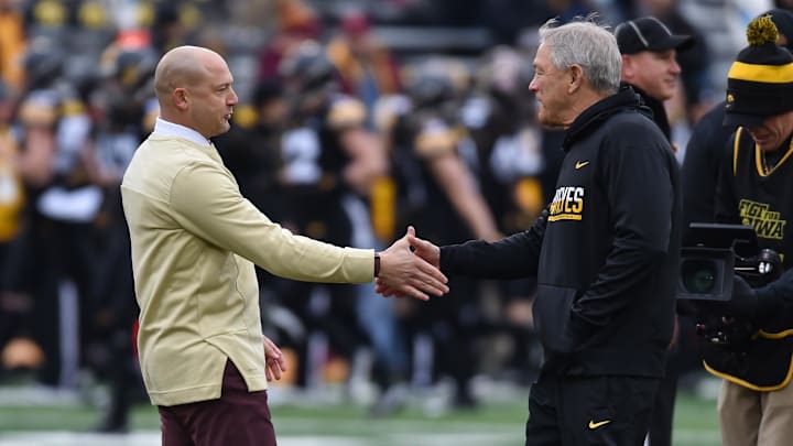 Nov 13, 2021; Iowa City, Iowa, USA; Minnesota Golden Gophers head coach P. J. Fleck (left) and Iowa Hawkeyes head coach Kirk Ferentz (right) shake hands before the game at Kinnick Stadium. Mandatory Credit: Jeffrey Becker-Imagn Images Nov 13, 2021; Iowa City, Iowa, USA; Minnesota Golden Gophers head coach P. J. Fleck (left) and Iowa Hawkeyes head coach Kirk Ferentz (right) shake hands before the game at Kinnick Stadium. Mandatory Credit: Jeffrey Becker-Imagn Images