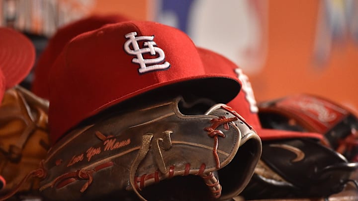 Jul 29, 2016; Miami, FL, USA; A detailed view of a hat and glove in the dugout of the St. Louis Cardinals in the game against the Miami Marlins at Marlins Park. The Cardinals defeated the Marlins 11-6. Mandatory Credit: Jasen Vinlove-Imagn Images