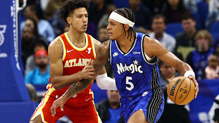 Jan 7, 2024; Orlando, Florida, USA; Orlando Magic forward Paolo Banchero (5) drives to the basket as Atlanta Hawks forward Jalen Johnson (1) attempted to defend during the first quarter at Kia Center. Mandatory Credit: Kim Klement Neitzel-Imagn Images