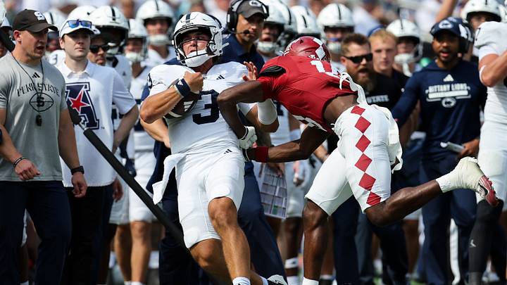 Penn State Nittany Lions quarterback Rocco Becht is tackled out of bounds by Temple Owls safety Kolin Dinkins during the fourth quarter at Lincoln Financial Field. Penn State Nittany Lions quarterback Rocco Becht is tackled out of bounds by Temple Owls safety Kolin Dinkins during the fourth quarter at Lincoln Financial Field.