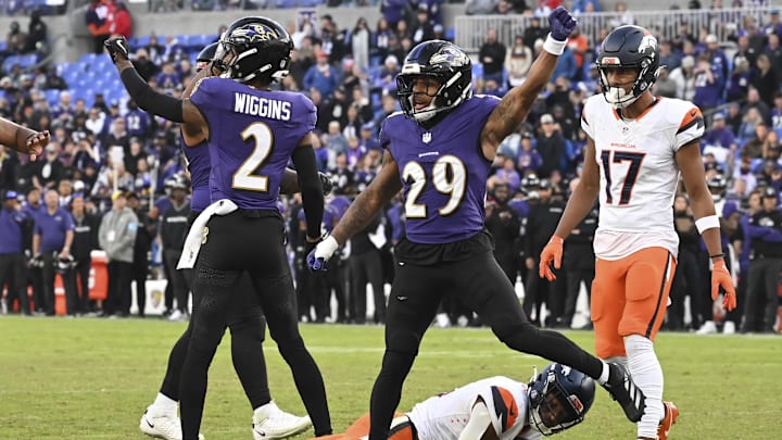 Nov 3, 2024; Baltimore, Maryland, USA; Baltimore Ravens cornerback Nate Wiggins (2) and safety Ar'Darius Washington (29) celebrate after tackling Denver Broncos wide receiver Courtland Sutton (14) on the one yard line on fourth down  the  during the  half at M&T Bank Stadium. Mandatory Credit: Tommy Gilligan-Imagn Images