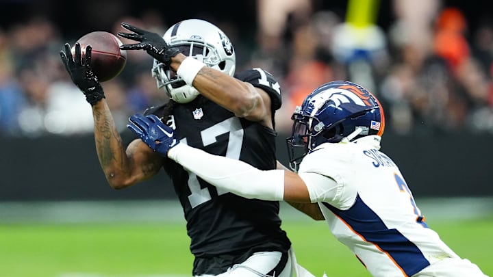 Jan 7, 2024; Paradise, Nevada, USA; Las Vegas Raiders wide receiver Davante Adams (17) makes a catch against Denver Broncos cornerback Pat Surtain II (2) during the second quarter at Allegiant Stadium. Mandatory Credit: Stephen R. Sylvanie-Imagn Images