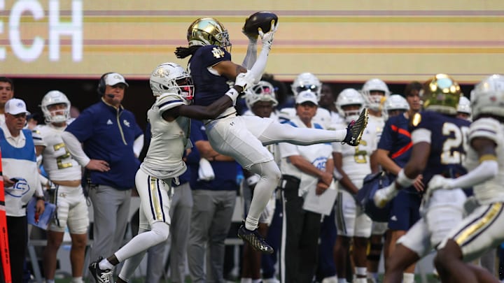 Oct 19, 2024; Atlanta, Georgia, USA; Notre Dame Fighting Irish safety Xavier Watts (0) intercepts a pass in front of Georgia Tech Yellow Jackets wide receiver Abdul Janneh Jr. (4) in the fourth quarter at Mercedes-Benz Stadium. Mandatory Credit: Brett Davis-Imagn Images
