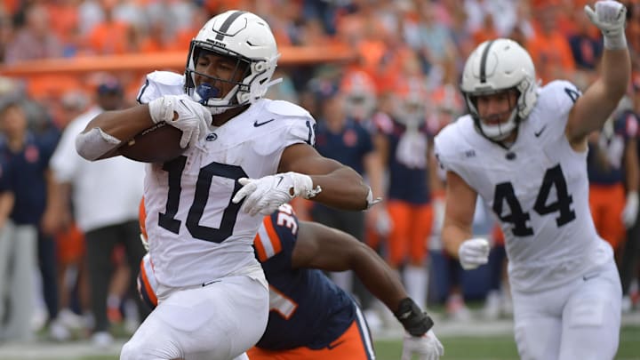 Sep 16, 2023; Champaign, Illinois, USA;  Penn State Nittany Lions running back Nicholas Singleton (10) scores a touchdown against the Illinois Fighting Illini during the second half at Memorial Stadium. Mandatory Credit: Ron Johnson-Imagn Images
