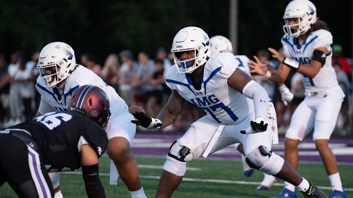 IMG's Jordan Seaton (77) protects his quarterback against a Lipscomb defender at Lipscomb's Reese
