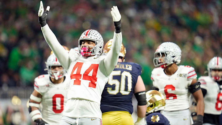 Ohio State Buckeyes defensive end JT Tuimoloau (44) celebrates a tackle of Notre Dame Fighting Irish running back Jeremiyah Love (4) in the first quarter during the College Football Playoff National Championship at Mercedes-Benz Stadium in Atlanta on January 20, 2025. Ohio State Buckeyes defensive end JT Tuimoloau (44) celebrates a tackle of Notre Dame Fighting Irish running back Jeremiyah Love (4) in the first quarter during the College Football Playoff National Championship at Mercedes-Benz Stadium in Atlanta on January 20, 2025.