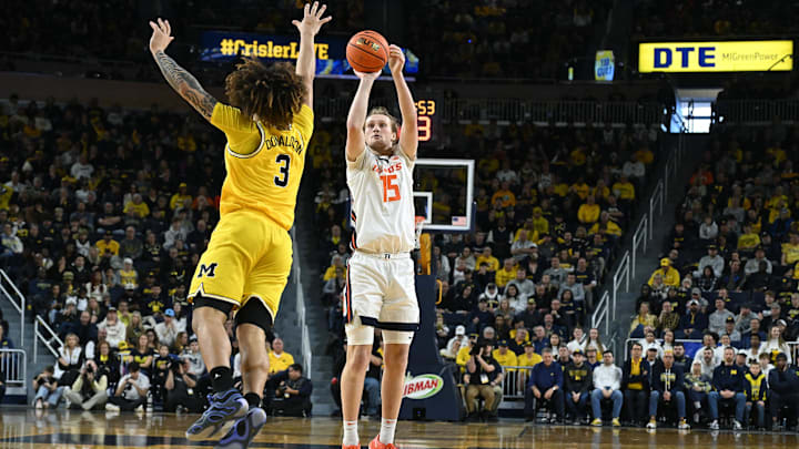 Mar 2, 2025; Ann Arbor, Michigan, USA; Illinois Fighting Illini forward Jake Davis (15) shoots a three point shot over Michigan Wolverines guard Tre Donaldson (3) in the second half at Crisler Center. Mandatory Credit: Lon Horwedel-Imagn Images