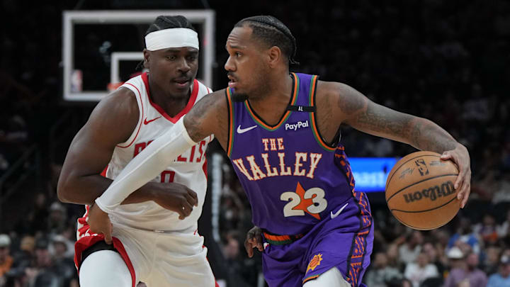 Mar 30, 2025; Phoenix, Arizona, USA; Phoenix Suns guard Monte Morris (23) drives on Houston Rockets forward Jae'Sean Tate (8) in the first half at Footprint Center. Mandatory Credit: Rick Scuteri-Imagn Images