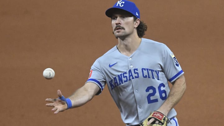Sep 10, 2025; Cleveland, Ohio, USA; Kansas City Royals second baseman Adam Frazier (26) tosses the ball to first base in the seventh inning against the Cleveland Guardians at Progressive Field. Mandatory Credit: David Richard-Imagn Images