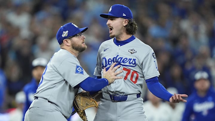 Nov 1, 2025; Toronto, Ontario, CAN; Los Angeles Dodgers third baseman Max Muncy (13) and pitcher Justin Wrobleski (70) react after Toronto Blue Jays shortstop Andres Gimenez (0) is hit by a pitch in the fourth inning during game seven of the 2025 MLB World Series at Rogers Centre. Mandatory Credit: John E. Sokolowski-Imagn Images Nov 1, 2025; Toronto, Ontario, CAN; Los Angeles Dodgers third baseman Max Muncy (13) and pitcher Justin Wrobleski (70) react after Toronto Blue Jays shortstop Andres Gimenez (0) is hit by a pitch in the fourth inning during game seven of the 2025 MLB World Series at Rogers Centre. Mandatory Credit: John E. Sokolowski-Imagn Images