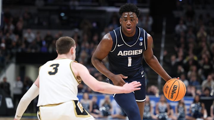 Mar 24, 2024; Indianapolis, IN, USA; Utah State Aggies forward Great Osobor (1) dribbles against