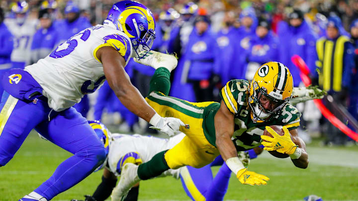 Green Bay Packers running back Aaron Jones (33) dives across the goal line for a touchdown against