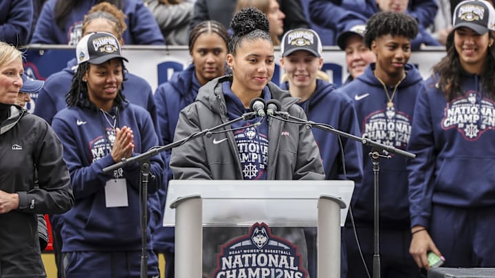 Apr 13, 2025; Hartford, CT, USA;   UConn student-athlete Azzi Fudd addresses the crowd while her teammates UConn student-athletes Paige Bueckers,  KK Arnold, Sarah Strong  and Ayanna Patterson look on during the Final Four champions victory parade and rally outside of the XL Center in Hartford, CT. Mandatory Credit: Scott Rausenberger-Imagn Images