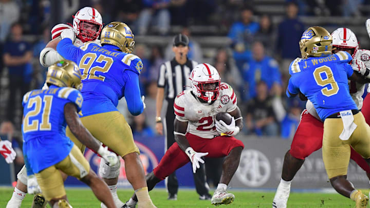 Nov 8, 2025; Pasadena, California, USA; Nebraska Cornhuskers running back Emmett Johnson (21) runs the ball against the UCLA Bruins during the second half at the Rose Bowl. Mandatory Credit: Gary A. Vasquez-Imagn Images