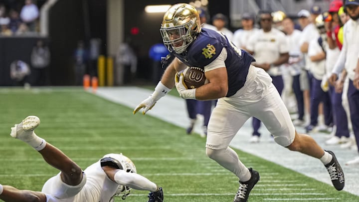 Oct 19, 2024; Atlanta, Georgia, USA; Notre Dame Fighting Irish running back Aneyas Williams  (20) runs against Georgia Tech Yellow Jackets defensive back Ahmari Harvey (3) during the first half at Mercedes-Benz Stadium. 