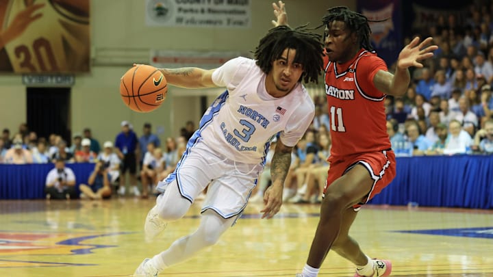 Dayton Flyers guard Malachi Smith (11), a former star at New York' City's St. Raymond, guards North Carolina Tar Heels guard Elliot Cadeau (3) during the an NCAA mens basketball game in Hawaii in November.
