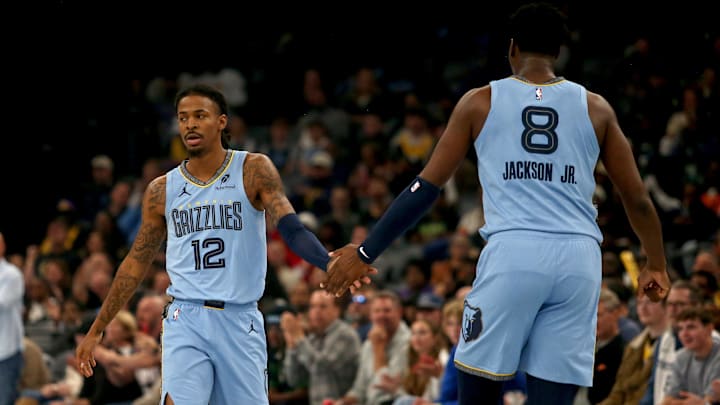 Oct 31, 2025; Memphis, Tennessee, USA; Memphis Grizzlies guard Ja Morant (12) reacts with forward/center Jaren Jackson Jr. (8) during the first quarter against the Los Angeles Lakers at FedExForum. Mandatory Credit: Petre Thomas-Imagn Images