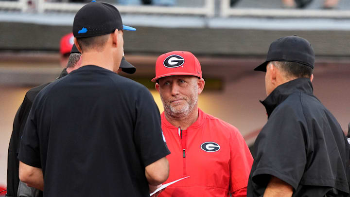 Georgia coach Wes Johnson meets with Kentucky coach Nick Mingione before the start of a NCAA baseball game on March 14, 2025.