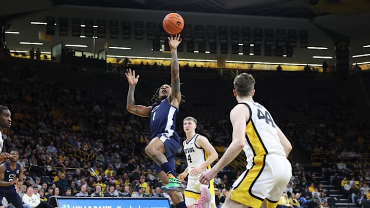 Penn State Nittany Lions guard Ace Baldwin Jr. splits the Iowa Hawkeyes defense during the first half at Carver-Hawkeye Arena. 