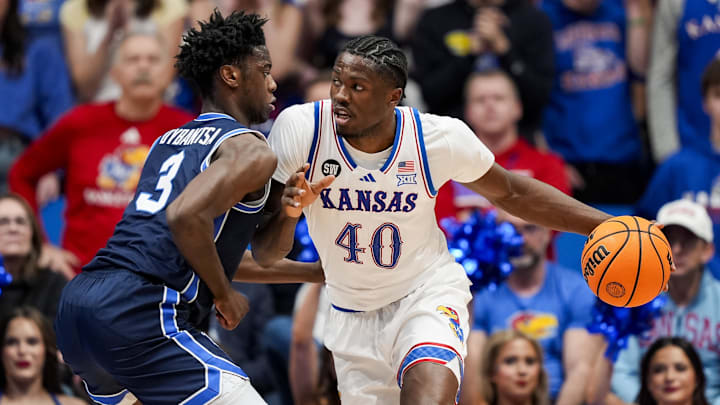Jan 24, 2026; Columbia, Missouri, USA; Kansas Jayhawks forward Flory Bidunga (40) drives against BYU Cougars forward AJ Dybantsa (3) during the first half at Mizzou Arena. Mandatory Credit: Jay Biggerstaff-Imagn Images