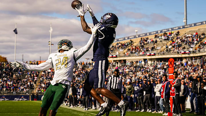 Nov 1, 2025; East Hartford, Connecticut, USA; UConn Huskies wide receiver Skyler Bell (1) makes the touchdown against UAB Blazers cornerback Tariq Watson (24) in the second quarter at Pratt & Whitney Stadium at Rentschler Field. Mandatory Credit: David Butler II-Imagn Images