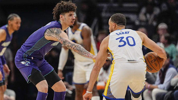 Mar 3, 2025; Charlotte, North Carolina, USA; Charlotte Hornets guard LaMelo Ball (1) on defense against Golden State Warriors guard Stephen Curry (30) during the second half at Spectrum Center. Mandatory Credit: Jim Dedmon-Imagn Images